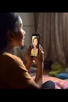 AI Generative Daughter talking with mother online using smartphone on video call Close up on phone screen focus on hands Quarantine mood photo