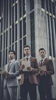 AI Generative Group of three modern business men of different age and ethnicity looking seriously at camera  Business life style concept with businessmen standing outside photo