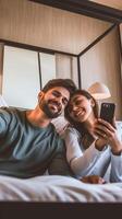 AI Generative Happy young couple taking selfie portrait with smart mobile phone lying on bed  Two lovers moving in new home photo