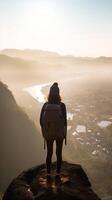 AI Generative Successful hiker with backpack climbing the mountain on sunset  Traveler woman standing on the top of the rock pointing the landscape  Freedom success and extreme sport concept photo