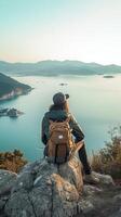 AI Generative Traveller backpacker girl on the top of the mountain looking at the ocean photo
