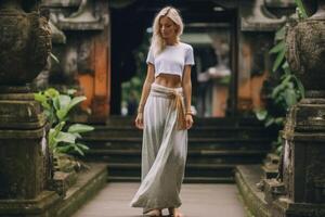 AI Generative Traveller woman posing in front of a temple in Bali Indonesia Woman with backpack on a trip in Asia photo