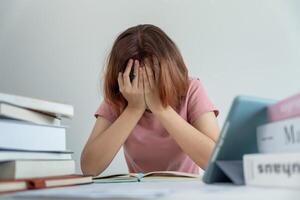 Asian student woman have anxiety because of exams, female prepare for test and learning lessons in the library. stress, despair, haste, misunderstanding reading, discouraged, expectation, knowledge photo