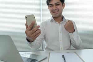 Asian handsome man exited surprise face expression . Male feels shocked with the phone. exciting smile and happy adorable rejoices. Very enjoy and fun relax time. wow, girl holding smartphone. photo