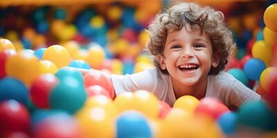 AI generated Joyful young boy with curly hair enjoying playtime in a vibrant ball pit at a children's indoor play center photo