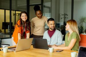 Young multiethnic startup team working in the modern office photo