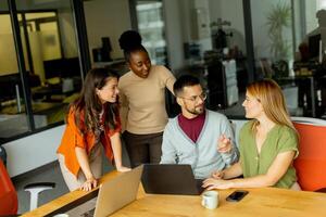 Young multiethnic startup team working in the modern office photo