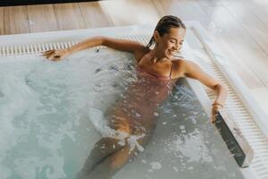 Young woman relaxing in the indoor bubble pool photo