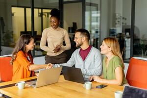 Young multiethnic startup team working in the modern office photo