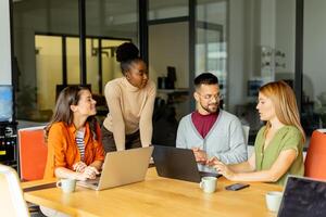 Young multiethnic startup team working in the modern office photo