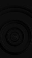 Vertical video - stylish dark abstract background with gently rotating concentric circles. This simple minimalist geometric background is full HD and a seamless loop.