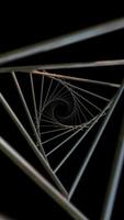 Vertical video - slowly moving through a shiny metallic triangular shaped spiral tunnel. Geometric motion background.