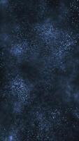 Vertical video - abstract flowing blue particles motion background animation with shallow depth of field - cosmic stars or galaxy effect.