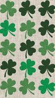 Vertical video - Saint Patrick's Day background animation - green shamrocks on traditional Irish linen fabric. This textured pattern motion background is full HD and a seamless loop.