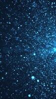 Vertical video - abstract background animation with glittering shiny blue particles and shimmering light rays. This sparkling motion background animation is full HD and a seamless loop.