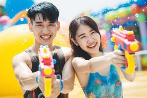 ai generado un Pareja jugando agua pistola a Songkran día con generativo ai foto