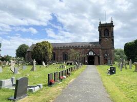 Bangor on Dee in the UK in July 2023. A view of a Church and Graveyard photo