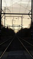 The railway view with the track and the colorful woods as background in the autumn morning photo