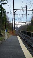 The railway view with the track and the colorful woods as background in the autumn morning photo