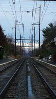 The railway view with the track and the colorful woods as background in the autumn morning photo