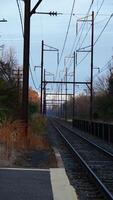 The railway view with the track and the colorful woods as background in the autumn morning photo