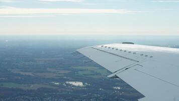 The airplane wing view looked from the flying plane window with the sunset sunlight on it photo