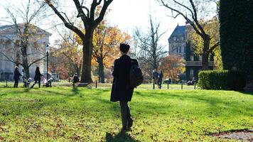 One student walking on the campus road with the warm sunlight. photo