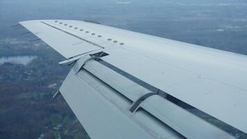 The airplane wing view looked from the flying plane window with the sunset sunlight on it photo