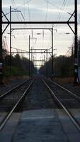 The railway view with the track and the colorful woods as background in the autumn morning photo