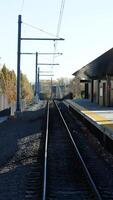 The railway view with the track and the colorful woods as background in the autumn morning photo