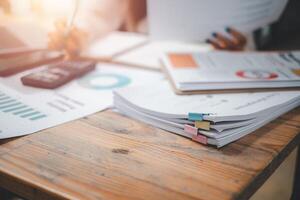 Stack overload document report paper with colorful paperclip place on office desk, paperless business concept. photo