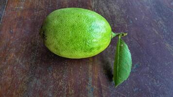 Ripe lemon fruit on branch with green leaves. Lemon fruit with green leaf. Natural Lemon fruit levitate. Fresh yellow ripe lemons. photo