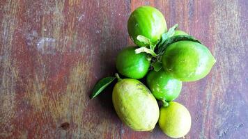 Ripe lemon fruit on branch with green leaves. Lemon fruit with green leaf. Natural Lemon fruit levitate. Fresh yellow ripe lemons. photo