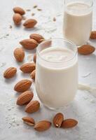 AI generated Almond Milk on White Table photo