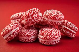 AI generated Red and White Swirl Candies on Red Background photo