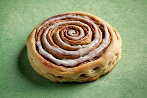 AI generated Classic Cinnamon Roll with White Icing on Green Background photo