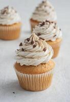 AI generated Vanilla Cupcakes with Chocolate Shavings photo