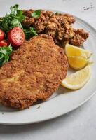 AI generated Crispy Breaded Cutlet with Lemon and Salad photo