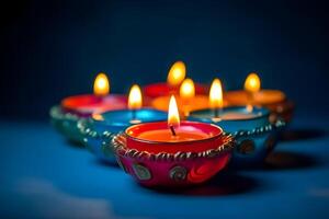 ai generado contento diwali - arcilla diya lamparas iluminado en azul antecedentes durante diwali celebracion, neural red generado fotorrealista imagen foto