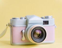 AI generated Retro analog film camera, pink equipment on colorful background photo