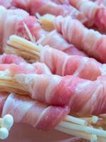 Needle Mushroom in the roll of thin sliced pork prepare to cook photo