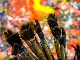 Old paintbrush on art work table photo