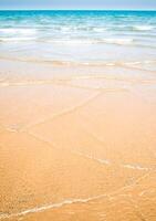 Light reflection on the surface of sea on sand beach photo