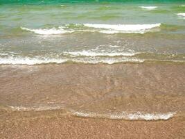 Bubble of Sea wave on the beach photo