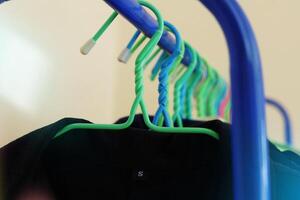 Clothes hanging on rack with light effect photo