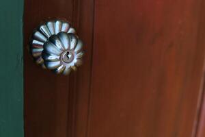 Door knob on wooden door for handle to enter or exit the room. photo