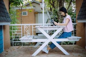 Young asian girl reading a book at the terraces photo