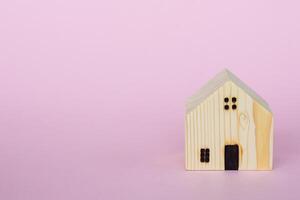 Wooden house model for housing concept photo