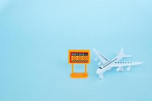 White airplane model with prohibition sign on blue background photo