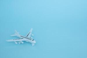 White airplane model on blue background photo